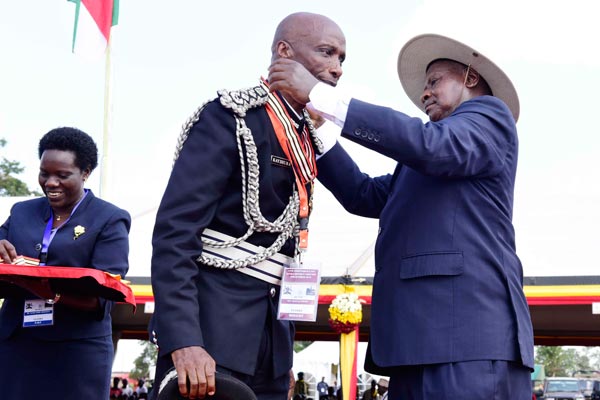 President Yoweri Museveni decorates the Inspector General of Police Kale Kayihura during the 2016 Independence Day celebrations in Luuka District on Sunday.