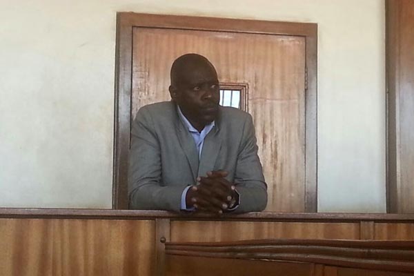 Former Old Kampala DPC Joram Tumwesigye in the dock at Buganda Road magistrates court on Friday.
