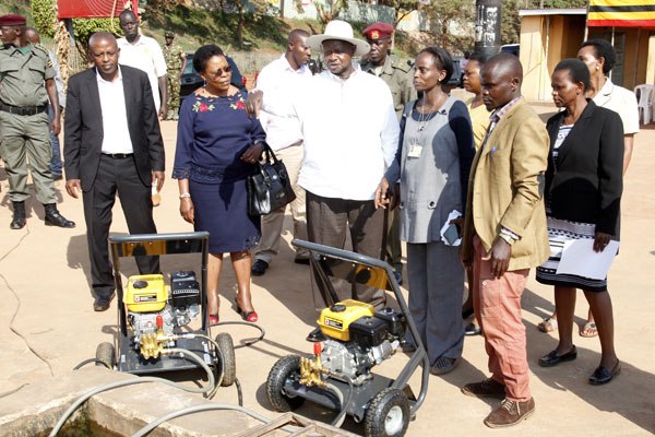 C- President Yoweri Museveni trial testing the water pumps that he donated to the Mulago car wash youth in Katanga on Friday 9/9/16.
