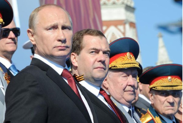 A file photo of Russia's President Vladimir Putin (L) and Prime Minister Dmitry Medvedev (2nd L) at a Victory Day parade