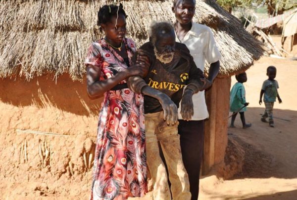 An old hungry Karamojong being man helped to get out of his house in Campswhaili chine in Moroto Municipality recently.