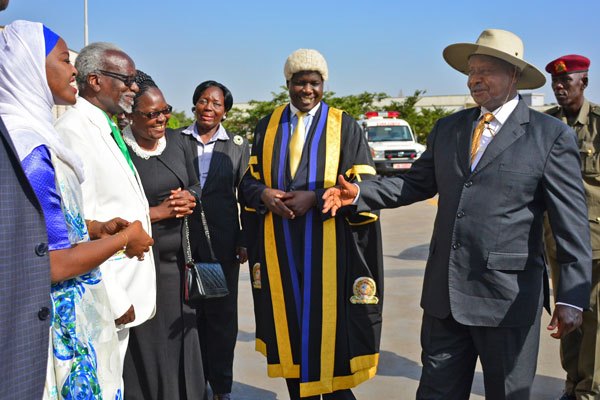 President Museveni shares a light moment with Eala members led by Speaker Dan Kidega (2nd L) during the opening of the 4th meeting of the 5th session at Parliament of Uganda in Kampala yesterday.
