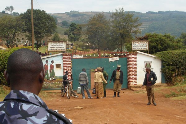 Policemen over seeing the situation at St Mary’s College Ruhoroza main gate after a student was shot dead as police tried to calm the striking students yesterday evening .
