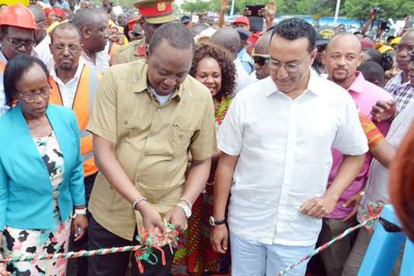 President Uhuru Kenyatta (centre), with Tourism Cabinet Secretary Najib Balala (right), commissions the Buxton Footbridge in Mombasa on January 5, 2017. He said leaders should focus on development.