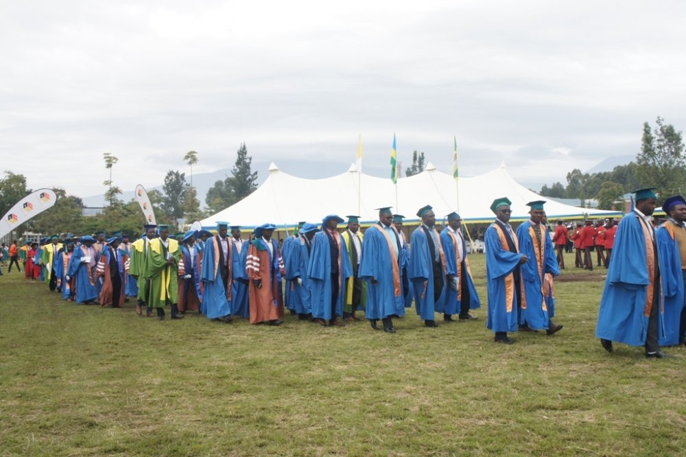 Lecturers and staff at INES-Ruhengeri walk towards seats at the graduation ceremony