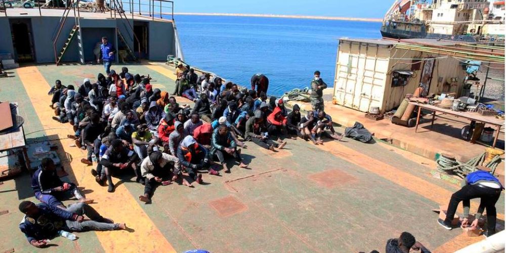 Rescued migrants sit aboard a Libyan coastguard vessel arriving at the capital Tripoli's naval base on February 28, 2021. Photo FP