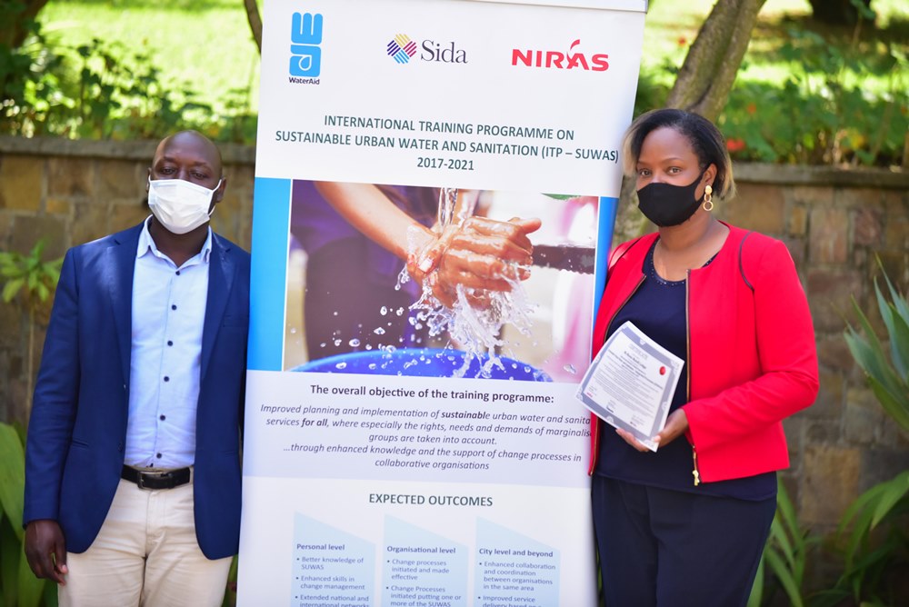 Jean Paul Mbarushimana, the Head of Programs for WaterAid Rwanda and the National facilitator for SUWAS with one of water and sanitation experts after completing the training. 