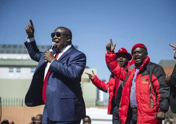 South Africa's Economic Freedom Fighter ( EFF) opposition leader Julius Malema addresses his supporters after his corruption trial was postponed on August 3, 2015 outside the High Court in Polokwane, South Africa.