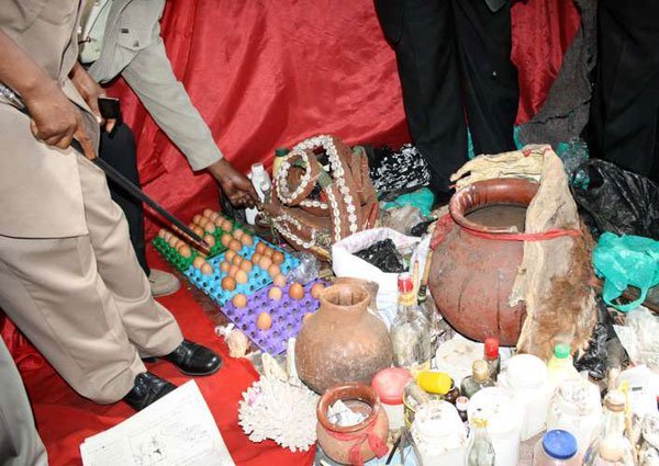 Administrators inspect suspected witchcraft paraphernalia unearthed during a raid in Langa Langa, Nakuru, on November 10, 2011. A man has been killed in Kwale County on accusations of practising witchcraft.