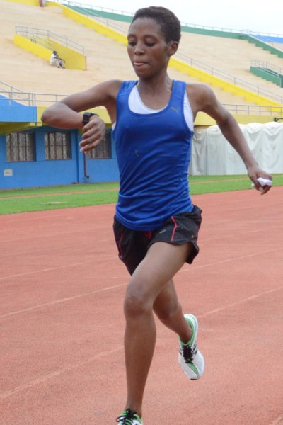 Nyirarukundo checks her watch as she nears the finish line.