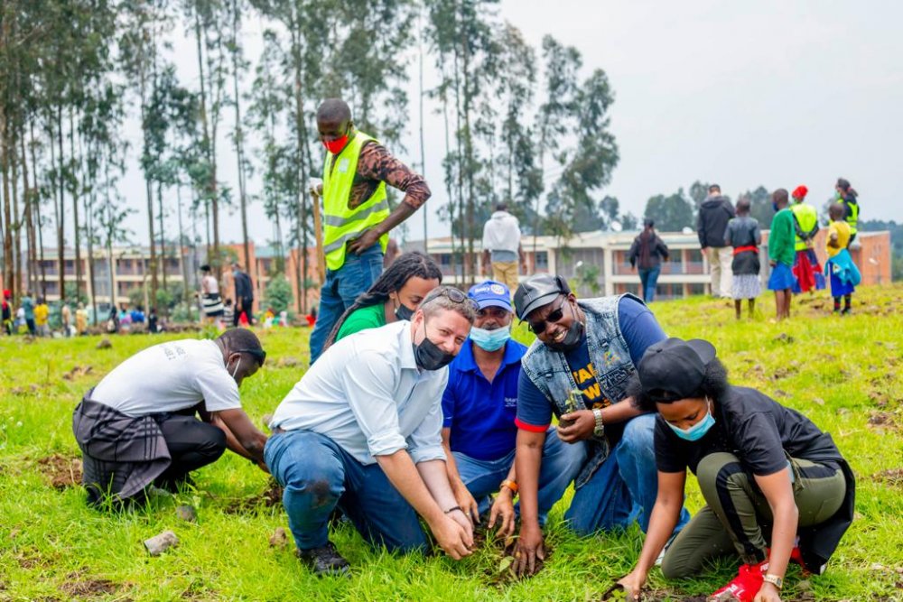 Rotary club members and partners planting trees in Kinigi model village.  