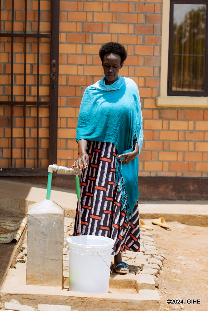 Mbabazi Jane is happy that she now has clean water at her home.