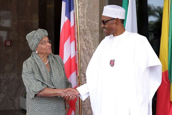 Nigerian President Muhammadu Buhari (right) greets President of Liberia Ellen Johnson Sirleaf in Abuja on January 9, 2017, before a meeting on the political situation in Gambia.
