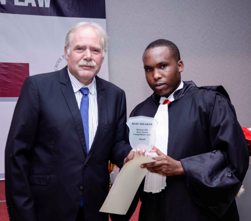 Kennedy Abuya (Right) with the award for the Second National Moot Court Competition on the law governing armed conflicts
