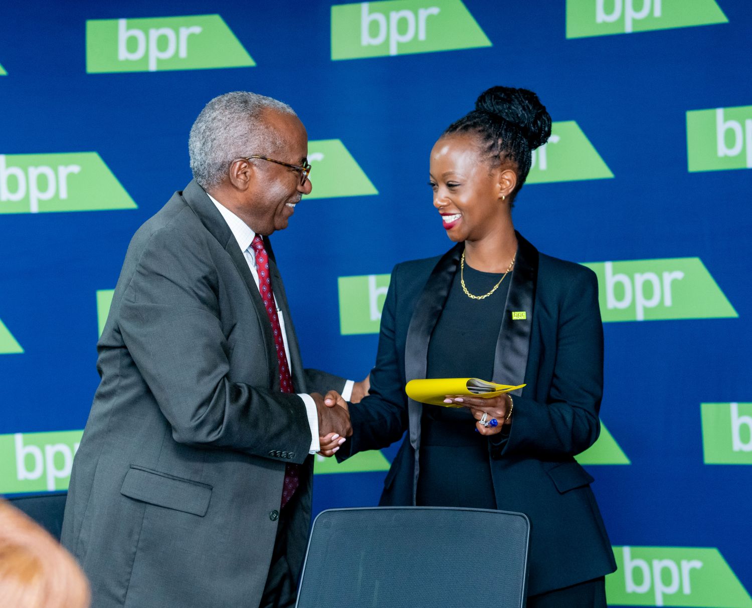 BPR Bank Rwanda Chairperson George Rubagumya and Managing Director Patience Mutesi exchange pleasantries during the unveiling of the audited financial results for 2024.