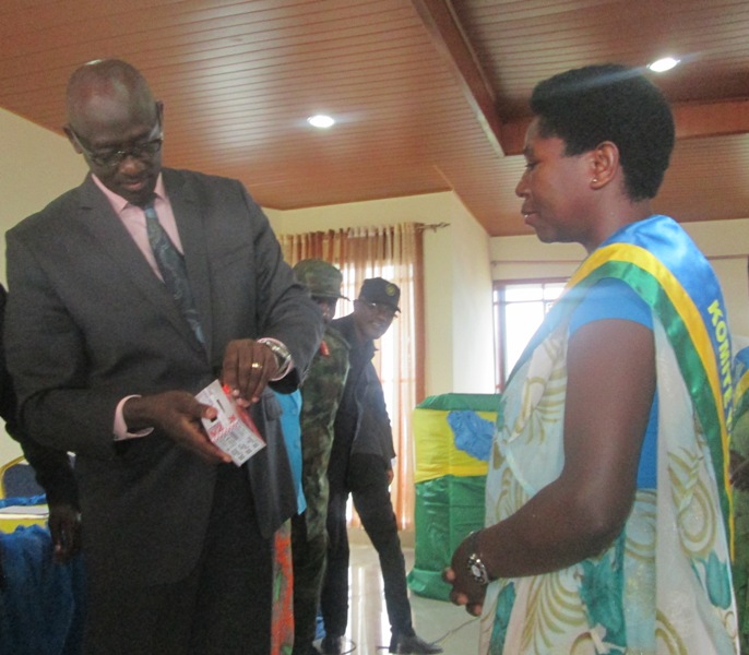 The Minister of Justice and Attorney General, Johnson Busingye handing phone donation to one of community mediators .