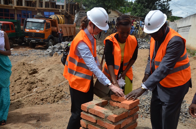 The Minister of Trade, Industry and East African Affairs François Kanimba laying a foundation stone at the construction site of the cross border market in Rusizi last Friday. 