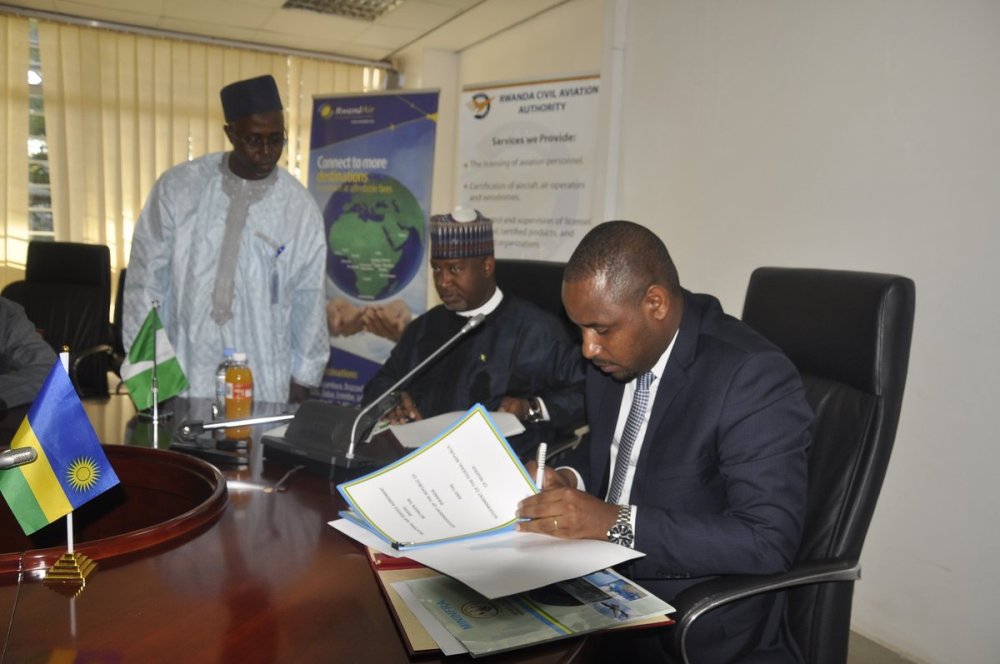 The State Minister in charge of Transport in the Ministry of Infrastructure, Jean de Dieu Uwihanganye (R) and Nigeria’s State Minister for Aviation, Sen. Hadi Abubakar Sirika sign the agreement