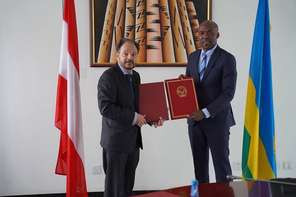 The Minister of Infrastructure, Dr. Ernest Nsabimana (right) and the Ambassador of Austria to Rwanda exchanging documents after signing the agreement.  