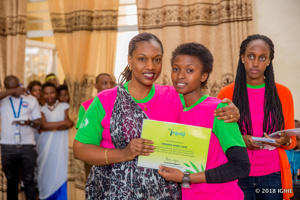 Minister Tumushime awards one of the students