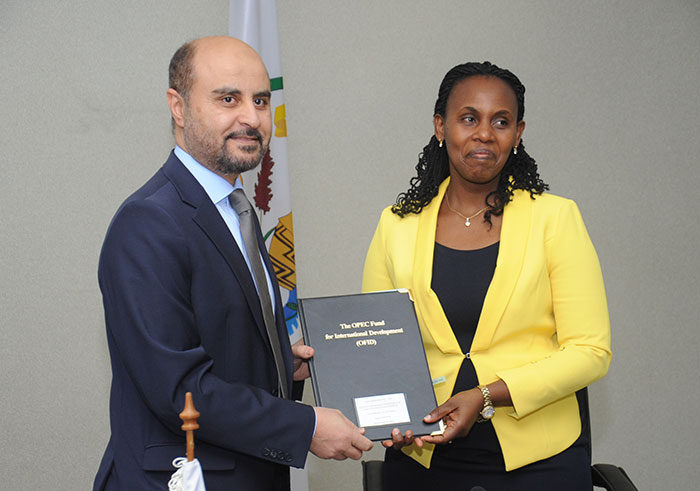 Minister of State of Finance and Economic Planning Dr Claudine Uwera, Director General of OPEC Dr Abudulhamid Al-khalifa  exchange documents after signing the agreement