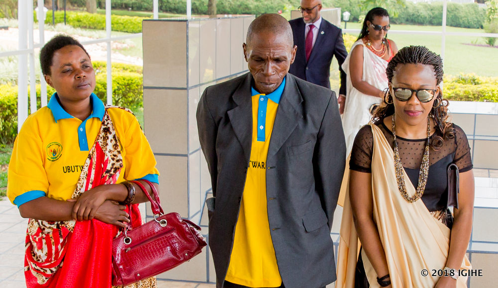 Umuhoza (R) and her family members commemorate national heroes