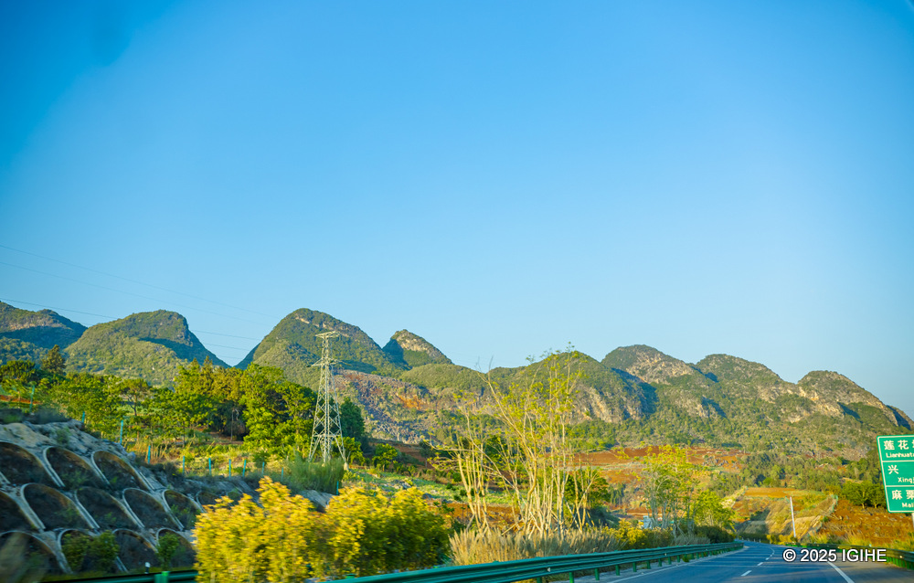 Mountain ridges fold into each other under a fading sun