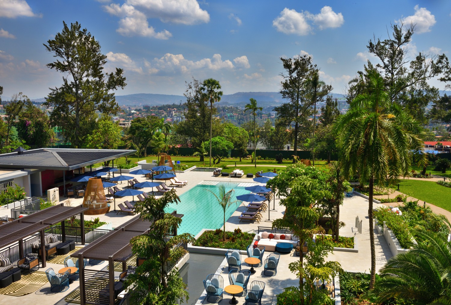 The heated outdoor swimming pool at Mövenpick Kigali offers guests a serene space to unwind while taking in the city’s lush skyline.