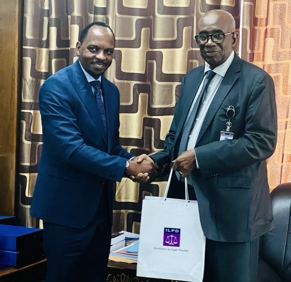 The Rector of the Institute of Legal Practice and Development (ILPD), Dr. Muyoboke Karimunda Aimé presenting a gift to the Chief Justice of Gambia.