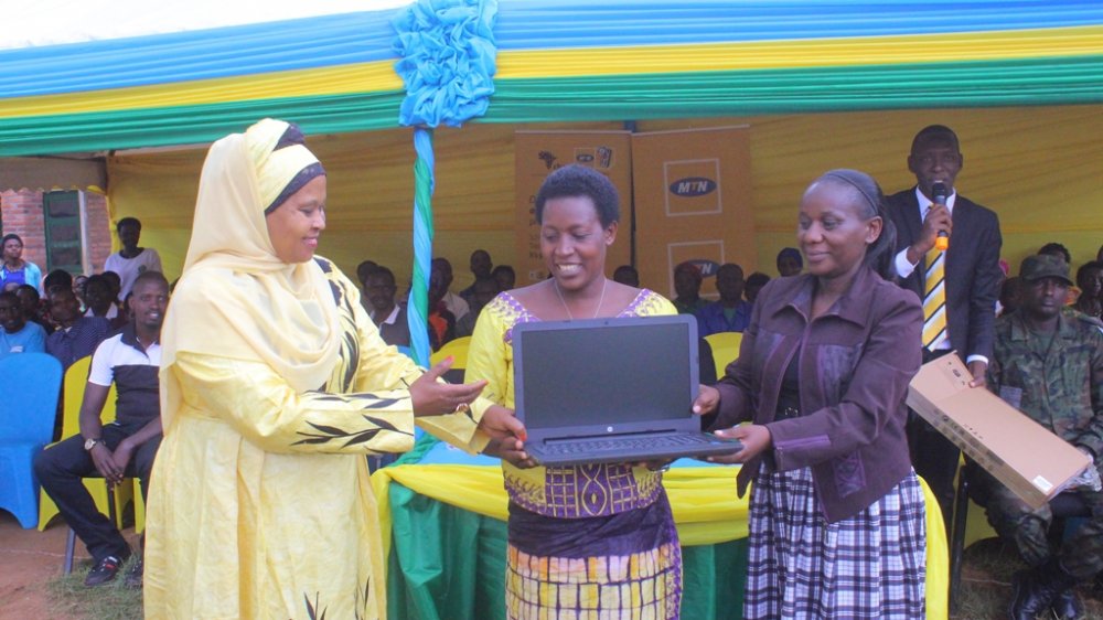 Zulfat Mukarubega, the Chairperson of MTN Foundation handing donations to Groupe Scolaire Kavumu on Wednesday.