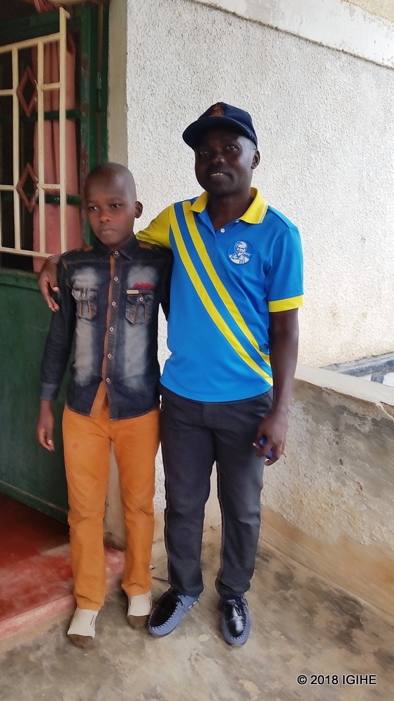Mugisha and his primary school teacher