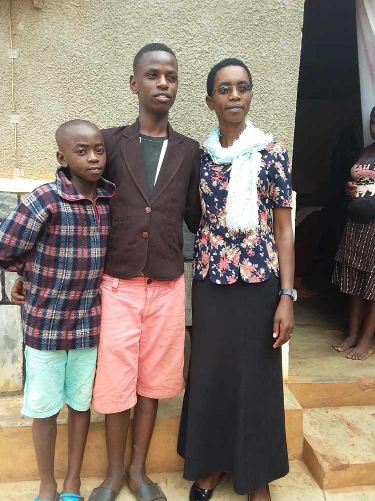 Mukarubuga, Patrick Cyubahiro (C) and her biological son (L)