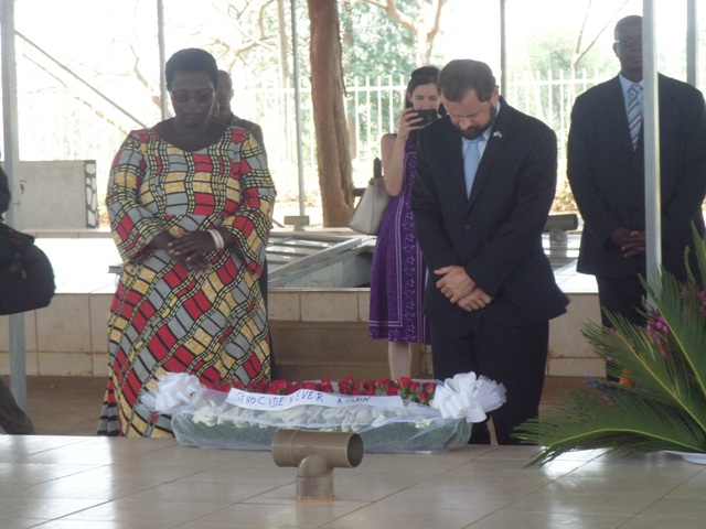 A Genocide Survivor with Thomas Perriello observe a minute of silence to honor the victims of the Genocide