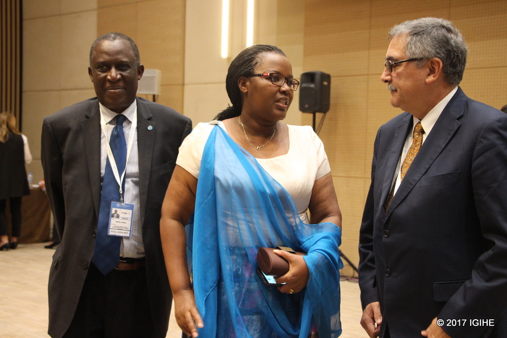 Minister Mukeshimana (C) chats with participants after the meeting
