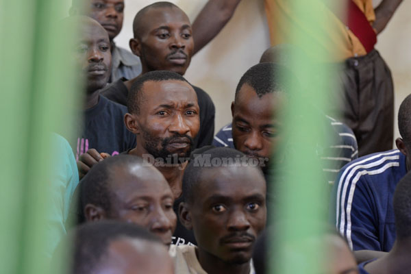 Some of the royal guards in police custody follow proceedings last year. At least 150 royal guards and the Rwenzururu King, Charles Wesley Mumbere have so far appeared before Jinja Magistrate's Court. Photo by Abubaker Lubowa