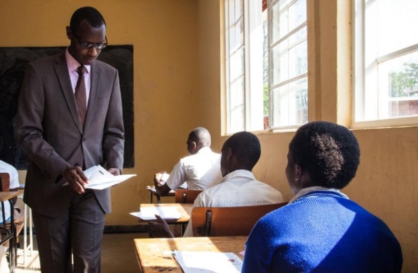 Minister for Education Papias Musafiri, distributes national exam papers at IPRC Kigali Technical Secondary School yesterday.
