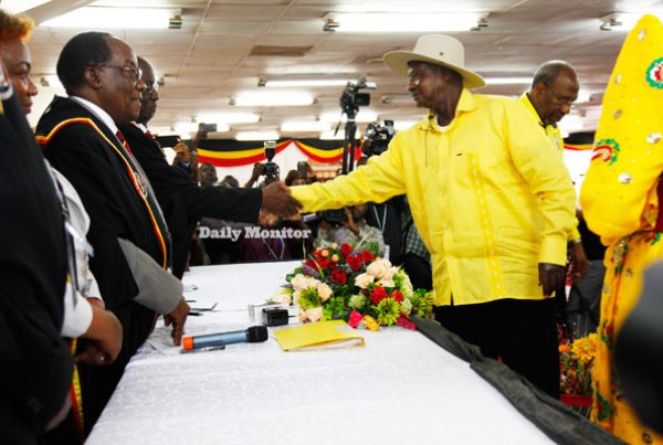 President Museveni (R) is received by Electoral Commission chairman Badru Kiggundu (L) at Mandela National Stadium, Namboole, during presidential nomination exercise yesterday.