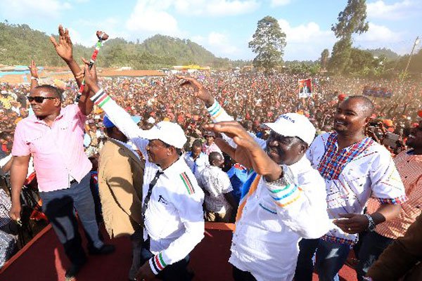 Nasa leaders Raila Odinga (second right) and Kalonzo Musyoka (second left) wave to a crowd at Laare stadium in Igembe North Constituency, in Meru on February 27, 2017. They are with ODM deputy elections director Bob Njagi (left) and Kajiado Central MP Memusi Kanchori (right). The leaders accused the government of tribalism and corruption.