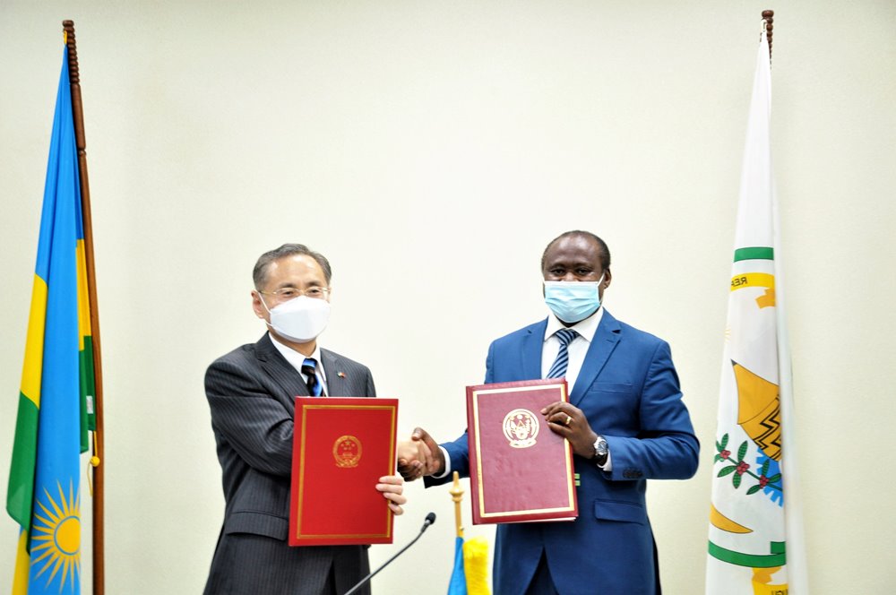 Dr. Uzziel Ndagijimana, the Minister of Finance and Economic Planning (right) exchanging documents with Chinese ambassador to Rwanda.  
