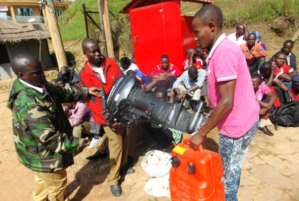 Rwandans carry a boat engine and other fishing materials that they were Intercepted with on Saturday.