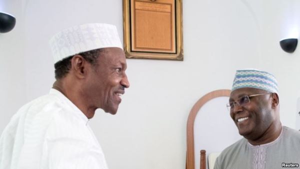 Nigeria's President Muhhamadu Buhari (L) is joined by former Vice President Alhaji Atiku Abubakar as they attend the Jumaat Prayers