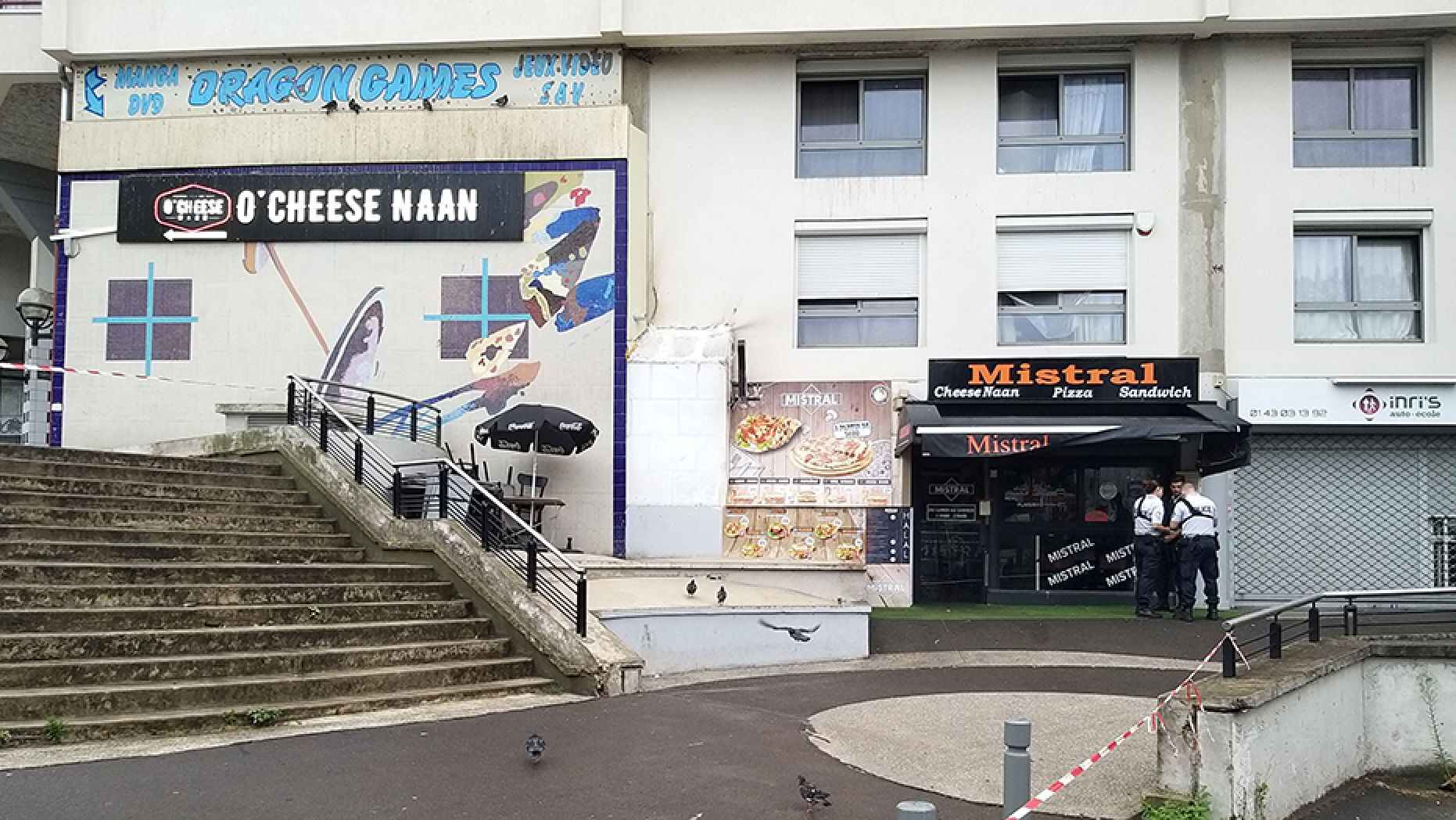 Policemen stand in front of the eatery on Saturday where a waiter was shot dead by a customer allegedly angry at having to wait for a sandwich, in the eastern Paris suburb of Noisy-le-Grand.