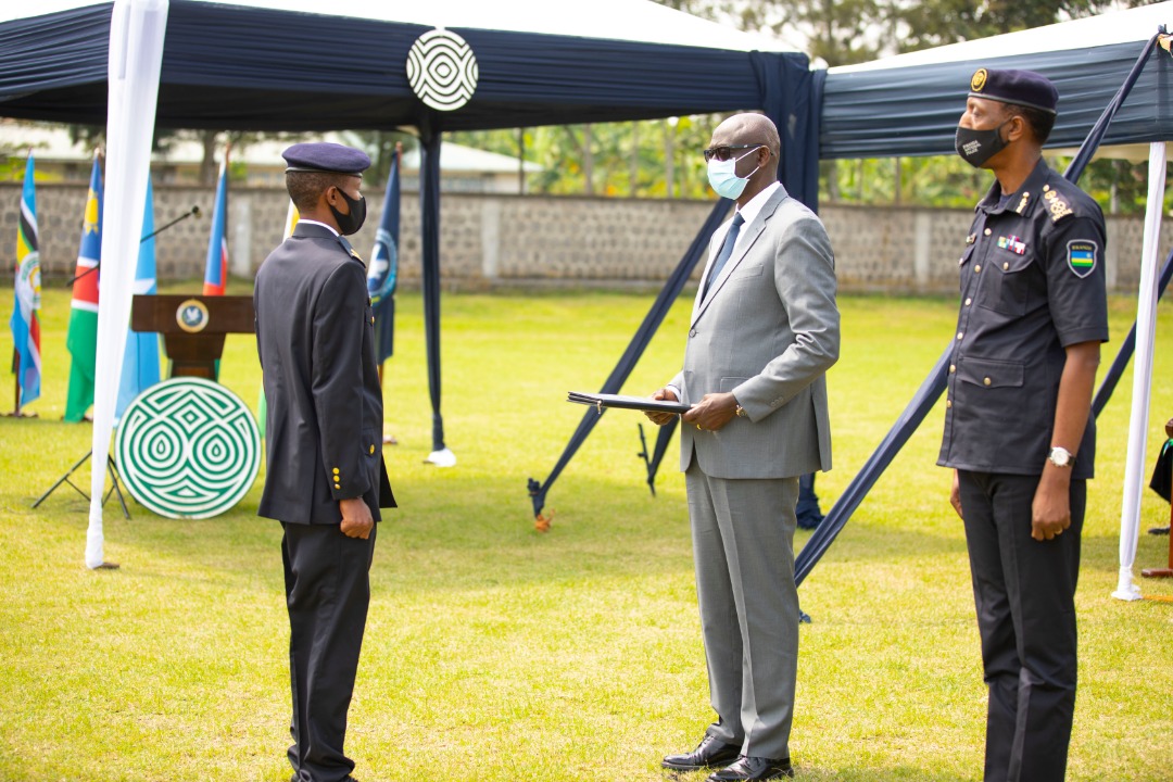 Minister of Justice and Attorney General, Johnston Busingye hands over an award to the best performer.