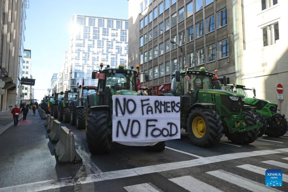 Tractors block a road during a protest in Brussels, Belgium, Feb. 1, 2024. Protesting farmers have blocked the roads with about 1,300 tractors around the European Union (EU) summit venue where the bloc's 27 leaders are gathered on Thursday, said the police. The protesters were understood to show their complaints about taxes, administrative overload, rising costs and cheap imports, and asked EU leaders for more help. (Xinhua/Zhao Dingzhe)