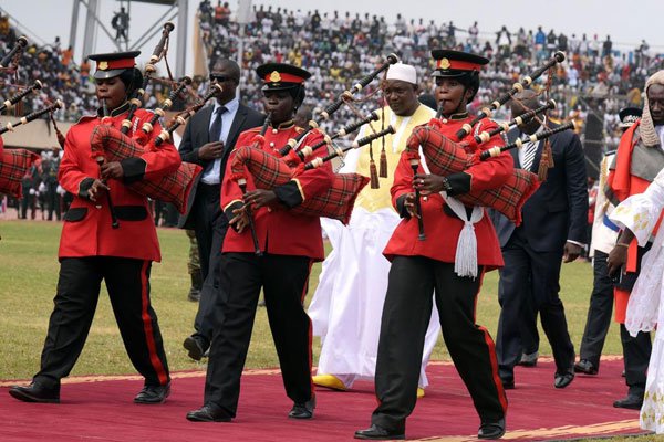Gambian President Adama Barrow (rear centre) is escorted after taking an oath during the inauguration ceremony for the start of his presidency in Banjul, on February 18, 2017. The new president recently pardoned scores of prisoners from three different jails.