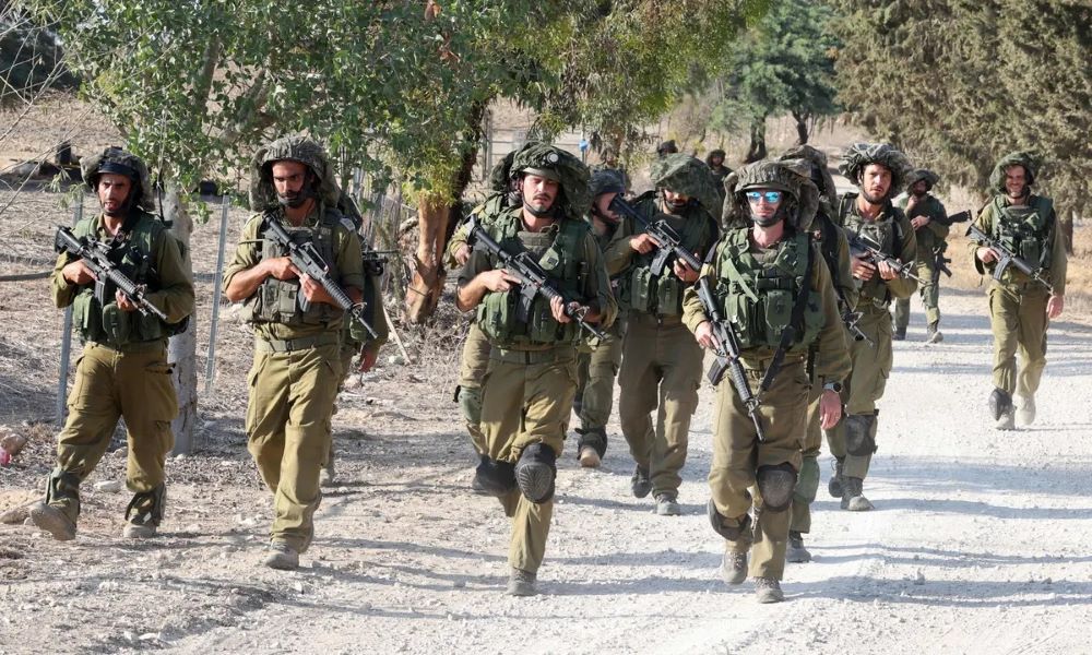 Israeli troops patrol at an undisclosed location along the border with the Gaza Strip. Photograph: Jack Guez/AFP/Getty Images