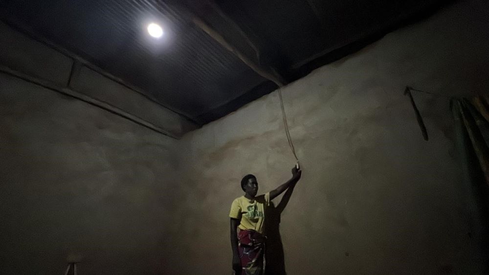 Oliva NIYITEGEKA, a resident of a neighbouring village who received a solar power system from PolyU three years ago. (Photo by Su Ting)