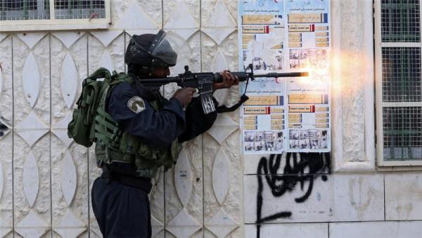 Israeli soldiers take up position during clashes with Palestinian protesters in the West Bank city of Hebron