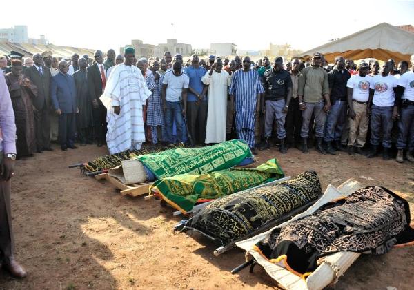 Malian Prime Minister Modibo Keita (2nd R) stands next to Malian President Ibrahim Boubacar Keita (3rd R) during the funerals of five victims of a shooting rampage at the luxury Radisson hotel in Mali's capital on November 20