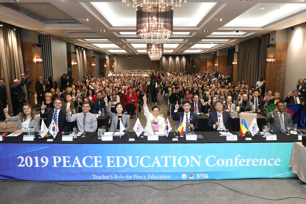 Participants shouting out 'We Are One' at the Peace Education Conference